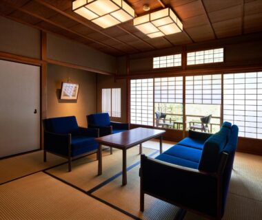 Traditional tatami room with low table, blue seating, shoji screens and balcony at Kyo no Yado Ishihara, Kyoto
