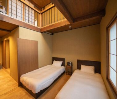 Twin beds with shoji screens and wooden interior featuring a mezzanine at Matsutani, Kyoto