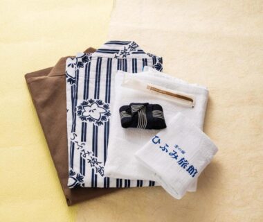 Folded striped yukata, sash and embroidered towel at HifumiRyokan Kyoto station