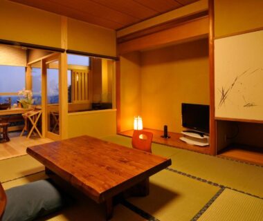 Traditional tatami room with low table, zabuton cushions and shoji screens at Syuhari守破離 in Chūbu, Shizuoka