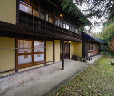 Two-story wooden ryokan exterior with shoji screens, Mahoroba in Nagano