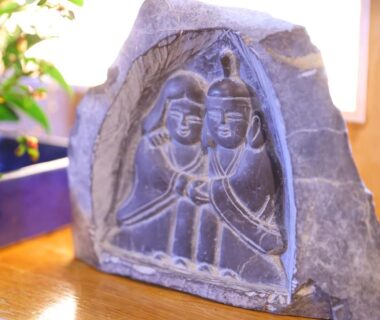 Carved stone relief of two figures at Ryokan Yama no Takohei in Hotaka Onsen Azumino Nagano
