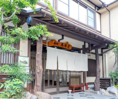 Noren curtain and wooden entrance of Manrikiya ryokan in Beppu Kannawa Onsen, Ōita