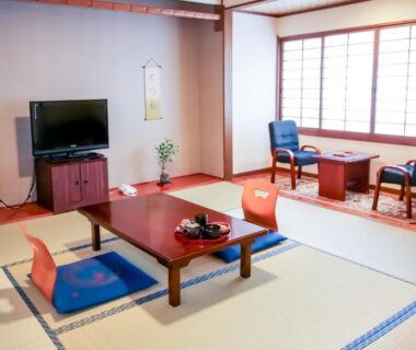 Tatami room with low table, zabuton cushions and shoji screens at Manrikiya, Beppu Kannawa Onsen, Ōita, Japan