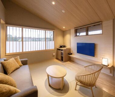 Wooden interior lounge with sofa, rattan chair and low table at Hakkaisan Konohanakan in Chūbu, Yamanashi