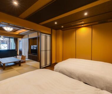 Tatami seating area and twin beds at Bettei Tateshina Kunpū in Nagano