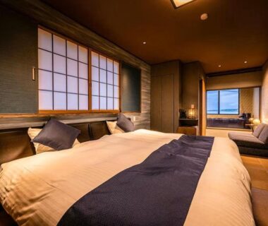 Modern guest room with western bed and shoji screens at Kappō Ryokan Kiyoto in Chiba, Kantō