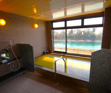 Indoor bathing area with large window overlooking waterfront at Ryokan Sakamotoya, Kyoto, Kansai, Japan