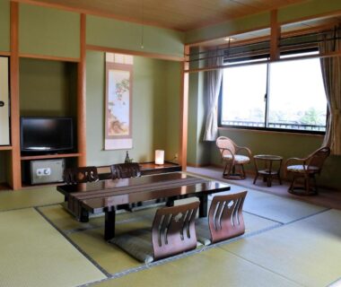 Traditional tatami room with low table, floor chairs, tokonoma and window seating at Ryokan Sakamotoya Kyoto