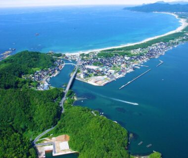 Aerial view of coastal bay, fishing harbor and green hills near Ryokan Sakamotoya in Kyoto, Kansai