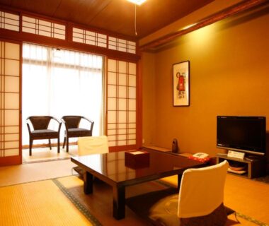 Traditional tatami room with low table, shoji screens and window seating at Kinosaki Onsen ryokan in Hyōgo