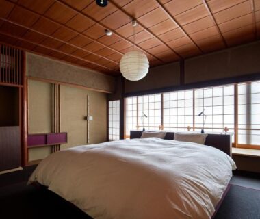 Tatami bedroom with futon and shoji screens at Kinosaki Onsen Ryokan Tsubakino in Hyogo, Kansai