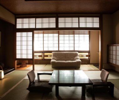 Spacious tatami room with low table, floor chairs, shoji screens and seating at Kinosaki Onsen ryokan in Hyōgo