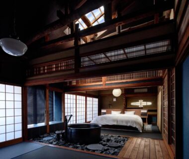 Traditional tatami room with bed, shoji screens, wooden bath and exposed beams in Kinosaki Hyogo