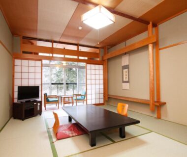 Traditional tatami room with low table, shoji screens and tokonoma at Hôtel touristique Tōnomine, Nara, Kansai