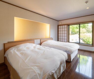 Twin Western beds with shoji door and garden view at Sansō Hanayu, Kumamoto, Kyūshū