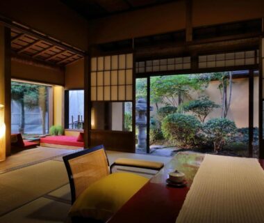 Traditional tatami room with low table, shoji screens and garden view at Tendoso ryokan in Yamagata