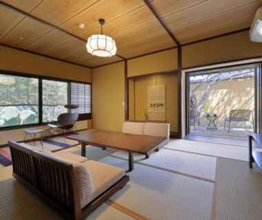 Tatami room with low table, sofa and shoji screens at 天童荘 TENDOSO in Tōhoku, Yamagata