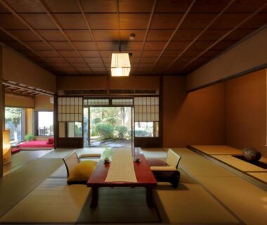 Spacious tatami room with low table, shoji screens and garden view at TENDOSO, Yamagata
