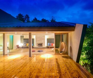 Illuminated open living area with wooden deck and hanging chair, Kaze no Mori, Oku-Takeo Onsen, Saga