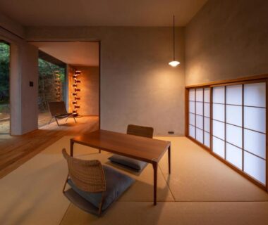 Tatami room with low table, zabuton chairs, shoji screen and garden view at Kaze no Mori, Saga