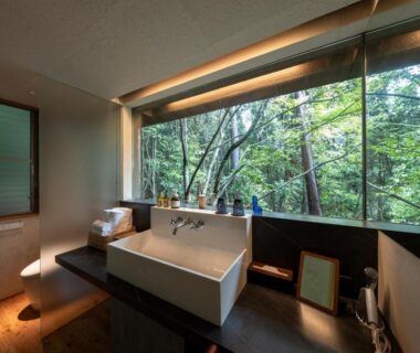 Washbasin and counter beside large window overlooking forest at Kaze no Mori, Oku-Takeo Onsen, Saga