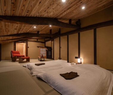 Tatami room with futons and exposed wooden beams at Wabi Sabi, Himeji, Hyōgo