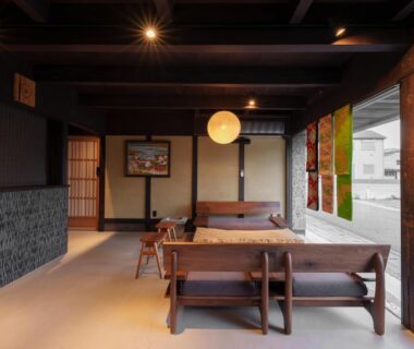 Spacious tatami lounge with low wooden seating, shoji screens and paper lantern at Wabi Sabi, Himeji, Hyōgo