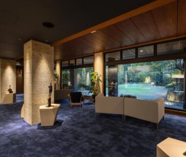 Spacious lounge with sofas and large windows overlooking garden at Kotan Ureshino in Ureshino Onsen, Saga