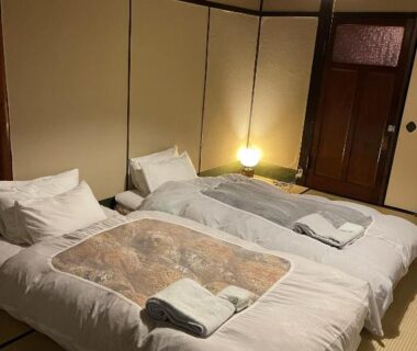 Two futon beds on tatami with sliding doors at auberge de Miyagawachō Kyoto