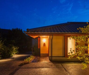 Lantern lit entrance with shoji doors and stone path at Shukubō Shingetsu in Saga Kyūshū
