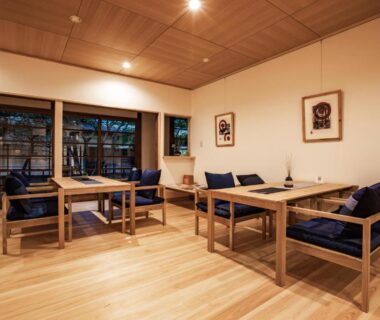 Wooden seating area with low tables and cushions at Temple Hotel Kannonin in Gunma, Kantō