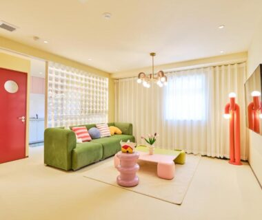 Tatami-style lounge with green sofa, low table and shoji screens at TORA HOTEL Okachimachi Tokyo