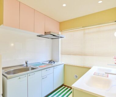 Small kitchenette with sink, stovetop, cabinets, counter and blinds at TORA HOTEL Okachimachi Tokyo