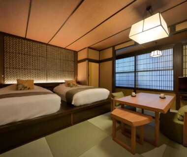 Tatami room with twin beds, shoji screens and low table at Yama no Chaya in Kanagawa