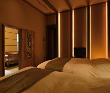 Warm-lit Japanese-style twin bedroom with low beds and shoji screens at Yama no Chaya in Kanagawa