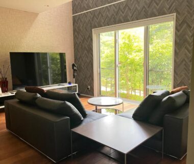 Living area with sofas, wooden floor and sliding doors at Yamashiroya Resort Nagano Chūbu Japan