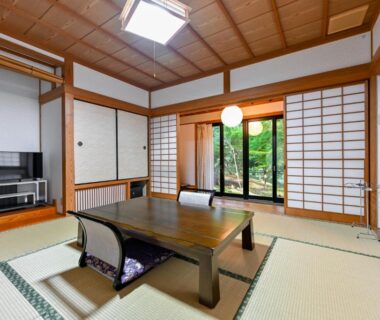 Traditional tatami room with low wooden table, shoji screens and garden view at Kosugian, Yamakawa Onsen, Kumamoto