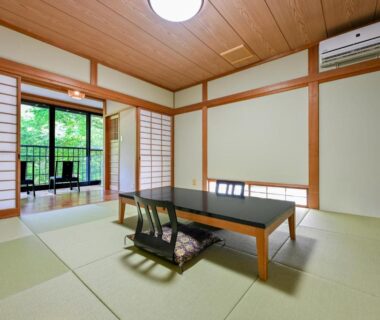 Tatami room with low table and shoji screens at Kosugian Yamakawa Onsen in Kumamoto, Kyūshū