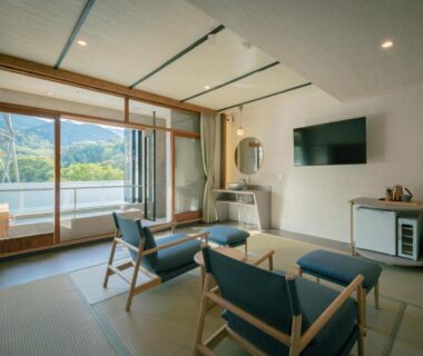 Tatami seating area with low chairs, balcony doors and mountain view at 巛-sen-Yugawara, Kanagawa, Kantō, Japan