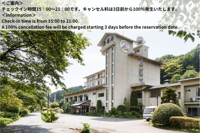 Ryokan exterior Shikibu no Yakata Izutsuya Fukushima Exterior of Shikibu no Yakata Izutsuya with entrance, landscaped shrubs and tree-covered hillside, Fukushima Tōhoku
