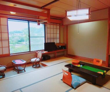 Traditional tatami room with low table and window view at Oyado Shinshima, Shizuoka