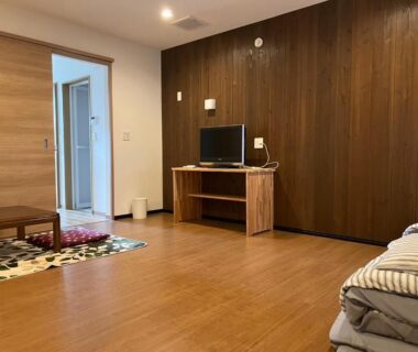 Low futon bedding and wooden floor in guest room at Oyado Daikonya, Kumamoto, Kyūshū