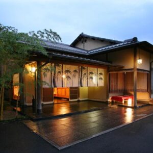 Illuminated wooden entrance with bamboo landscaping at Oyado Chikurintei in Saga, Kyushu, Japan