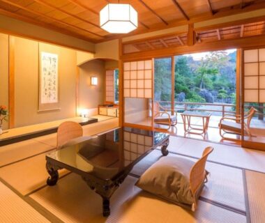 Traditional tatami room with low table, shoji screens and garden view at Oyado Chikurintei in Saga, Kyūshū