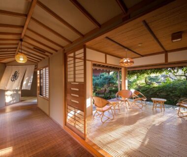 Bright tatami room with low seating and open shoji overlooking a landscaped garden at Oyado Chikurintei in Saga