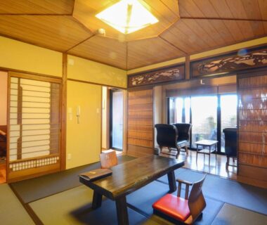 Traditional tatami room with low table and shoji screens at Toku no Yado Fubuan in Ōita, Kyūshū