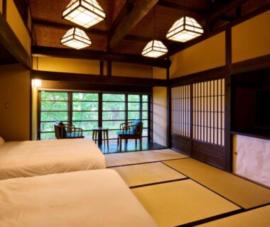Tatami flooring, low Western beds, shoji screens and garden-facing windows at Retraite Kominka Gunma