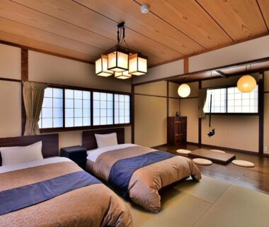Tatami room with two low beds, shoji screens and wooden ceiling at Tamano-yu, Togura Kamiyamada Onsen, Nagano