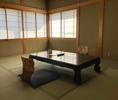 Traditional tatami room with low wooden table, zabuton cushions and shoji screens at Ryokan gastronomique Komakusa in Gifu, Chūbu, Japan